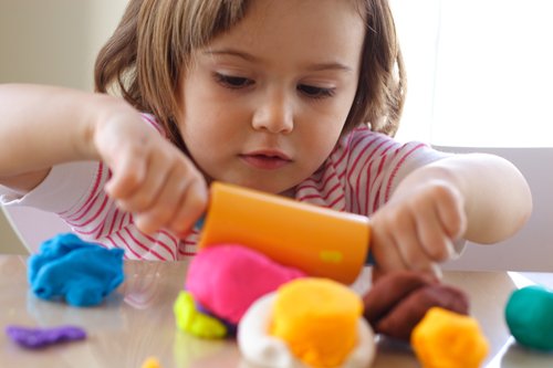 child playing with play dough 2